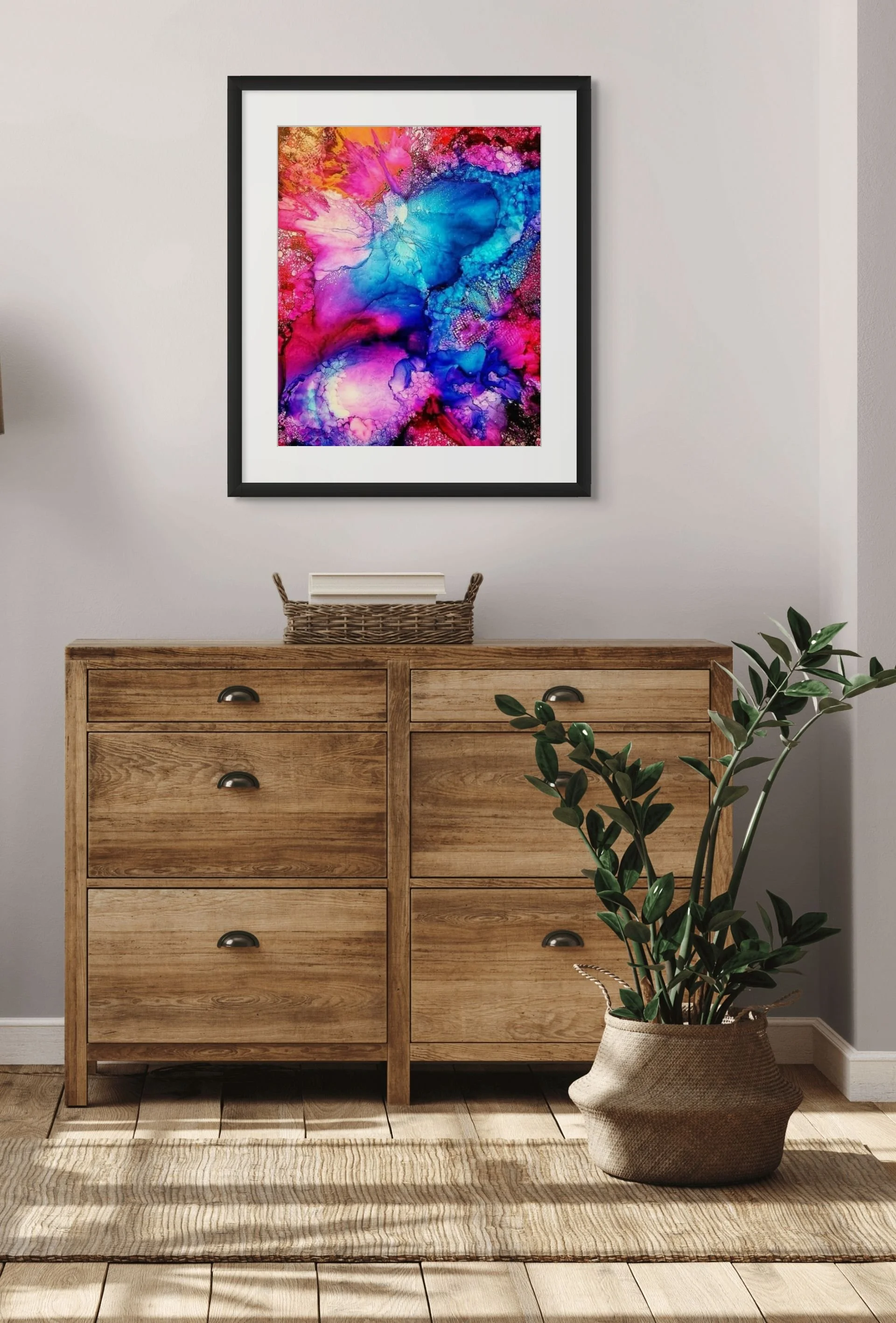 Abstract alcohol ink wall art displayed above a modern console table with celestial teal, gold, and purple textures for stylish home decor.