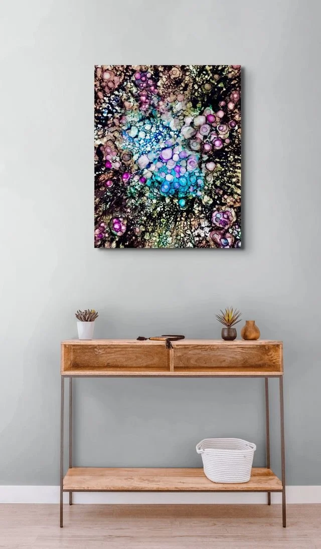Molecules of Love canvas print displayed above wood entryway console table