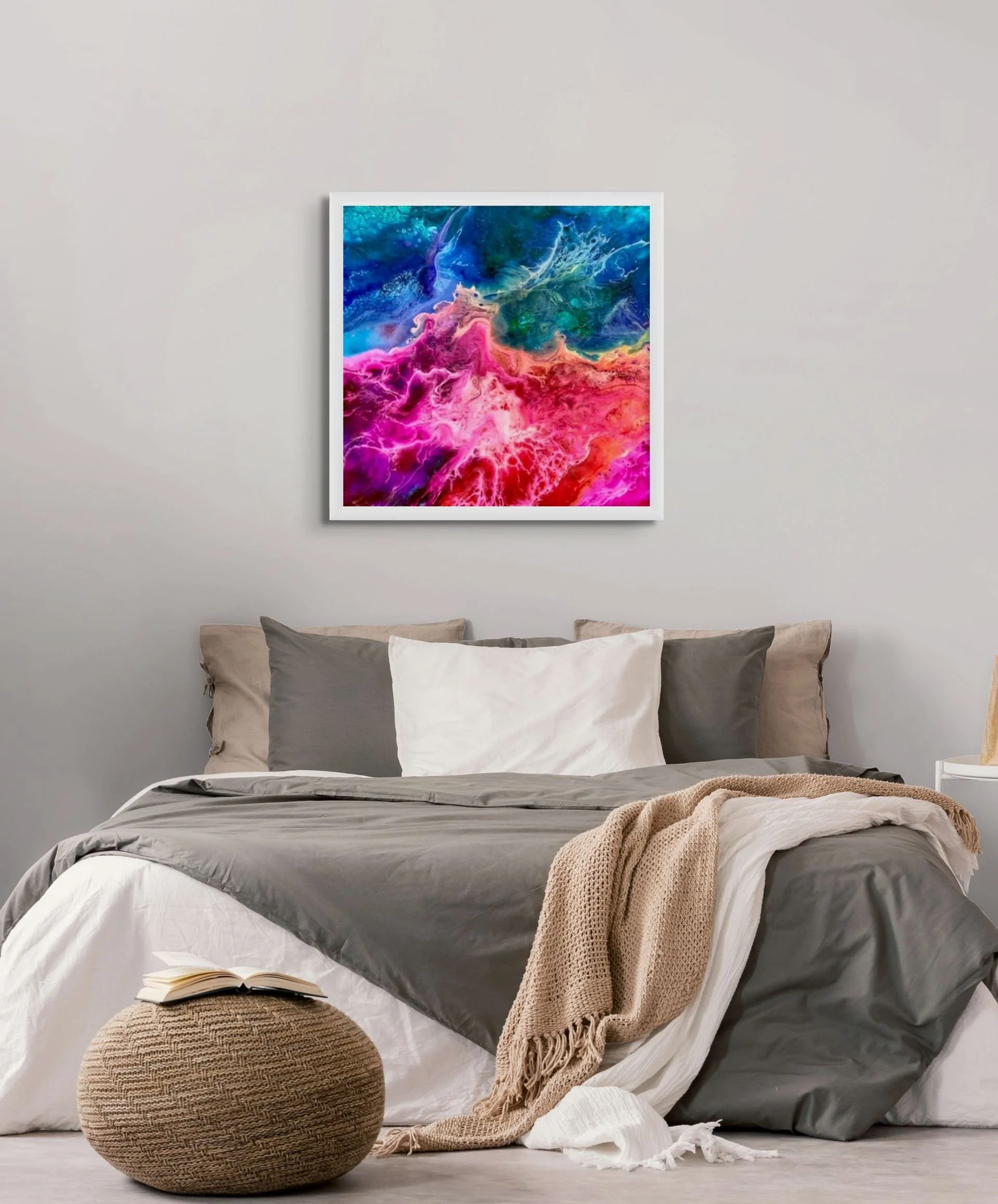 Pink and blue abstract wall art hanging above a bed in a colorful modern bedroom with vibrant contemporary decor.