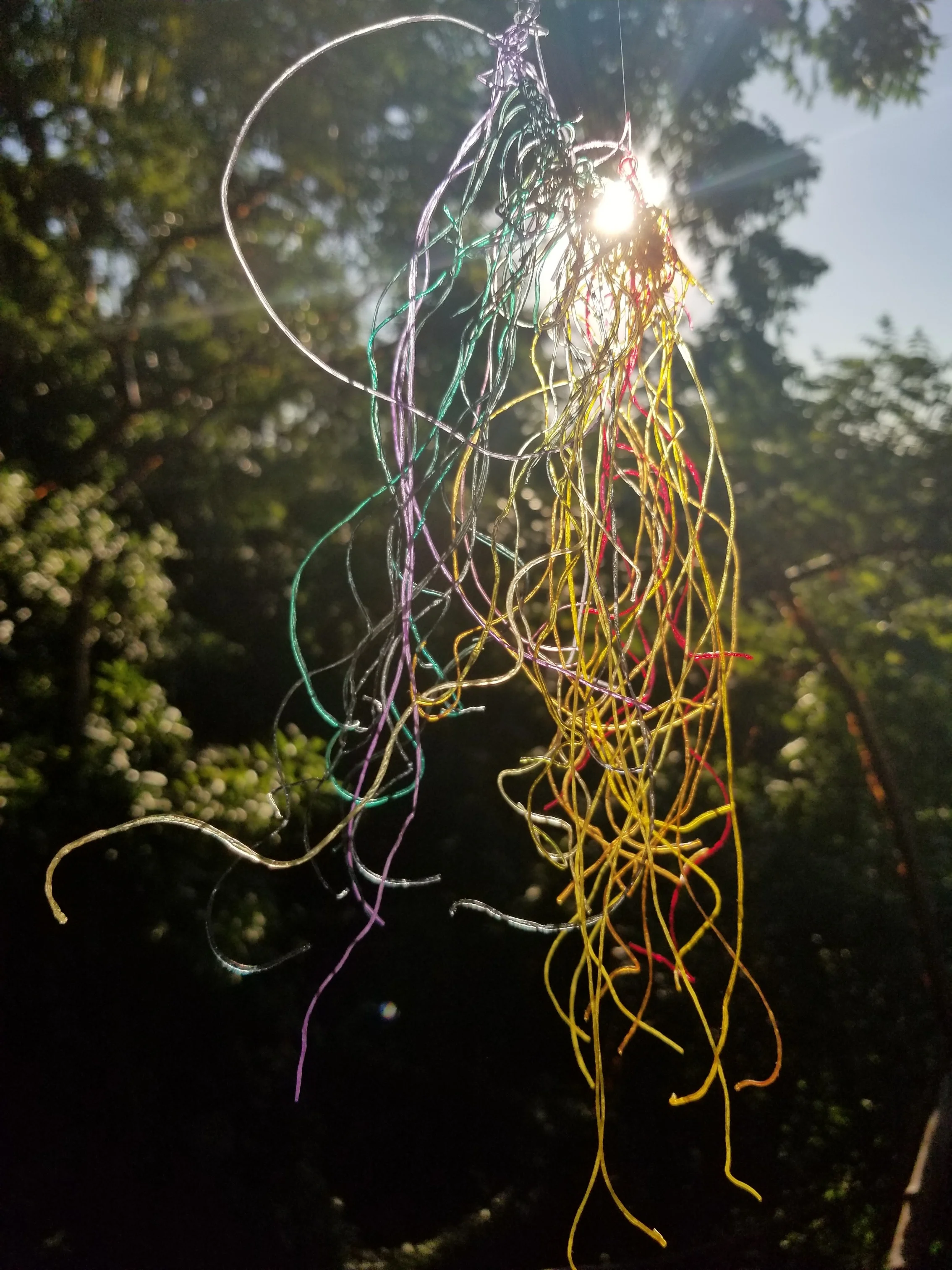 Mung bean infused with organic dyes hanging in the Mexican sun.