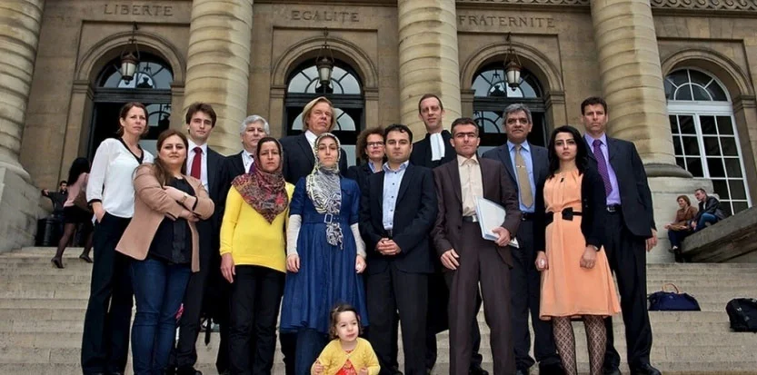 victims & attorneys on Paris courthouse steps.jpg