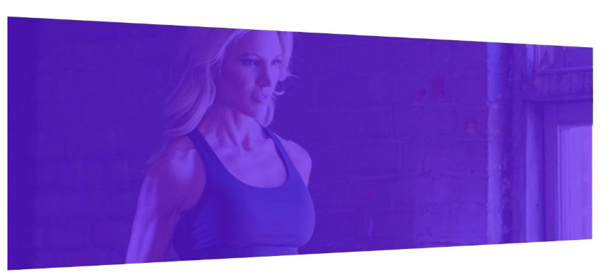 A woman with blonde hair in workout attire standing against a purple background.