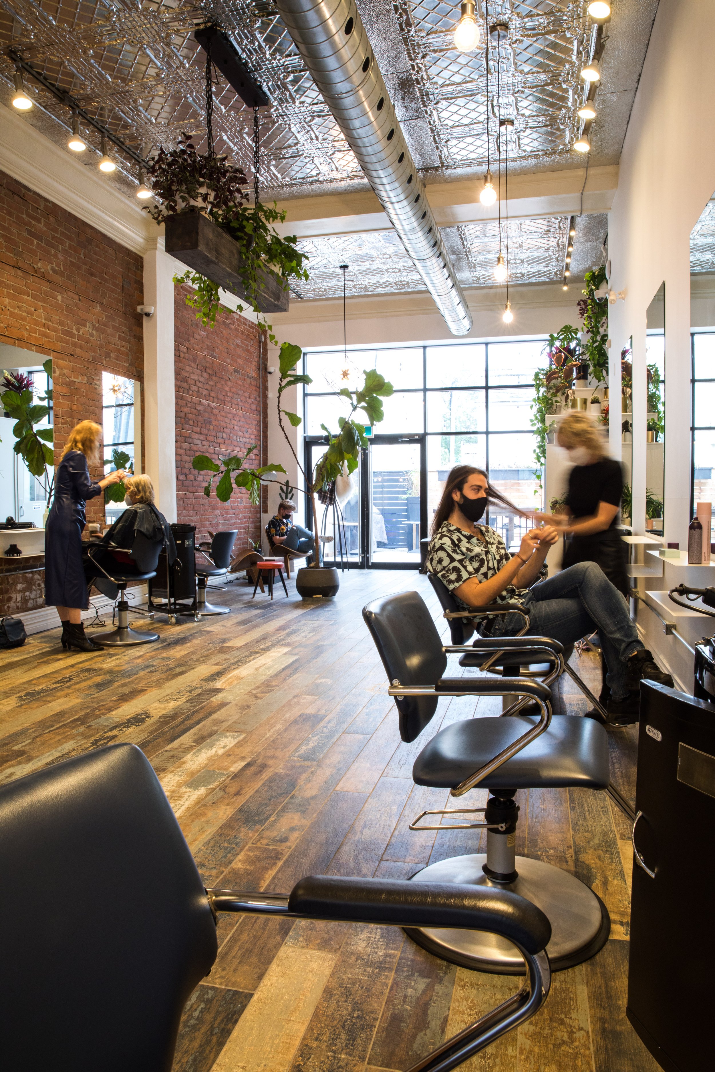 Stylist working in bright modern hair salon.