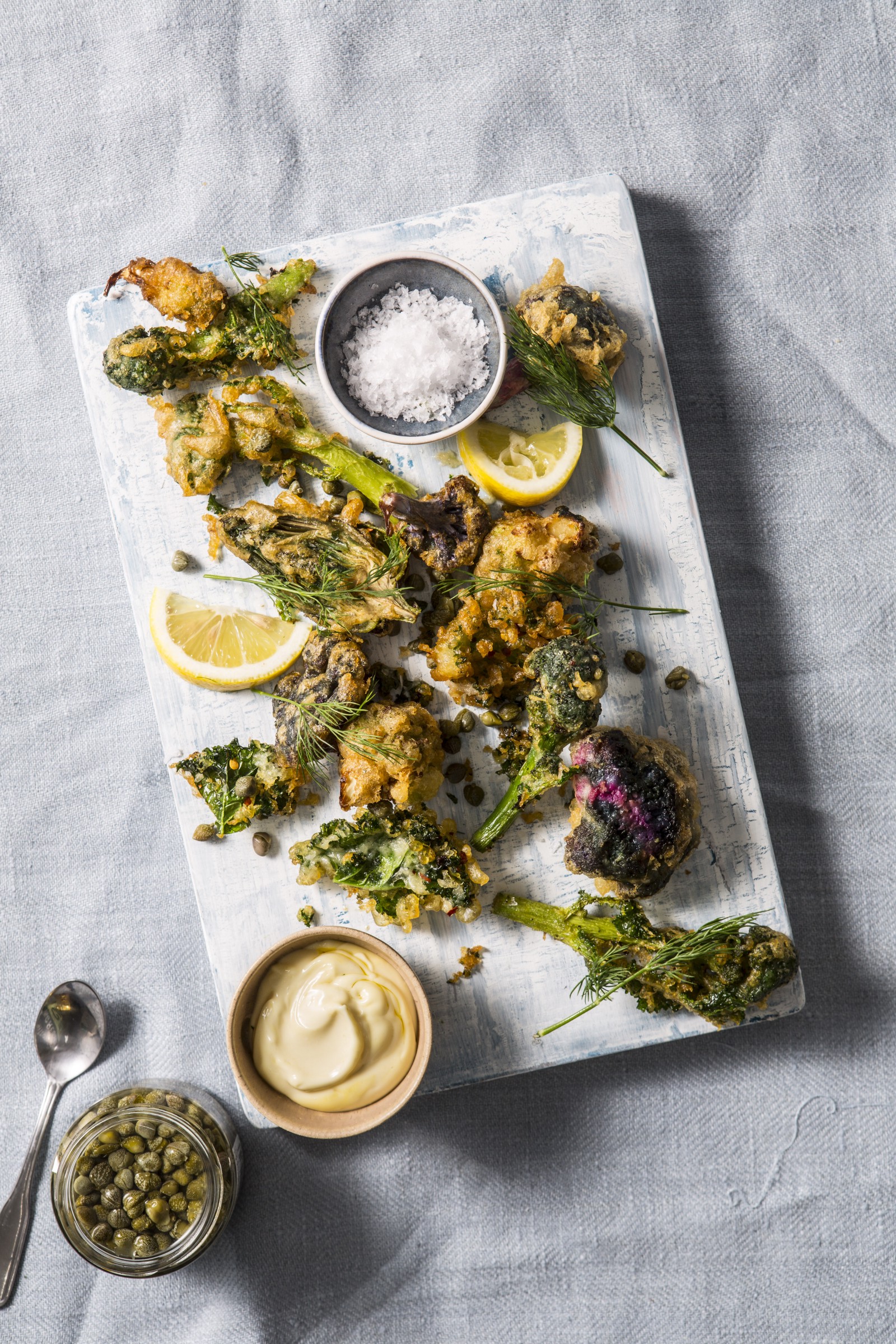 “Flat lay of fried vegetable fritters with broccoli, kale, and capers” by Stefan Johnson on Unsplash