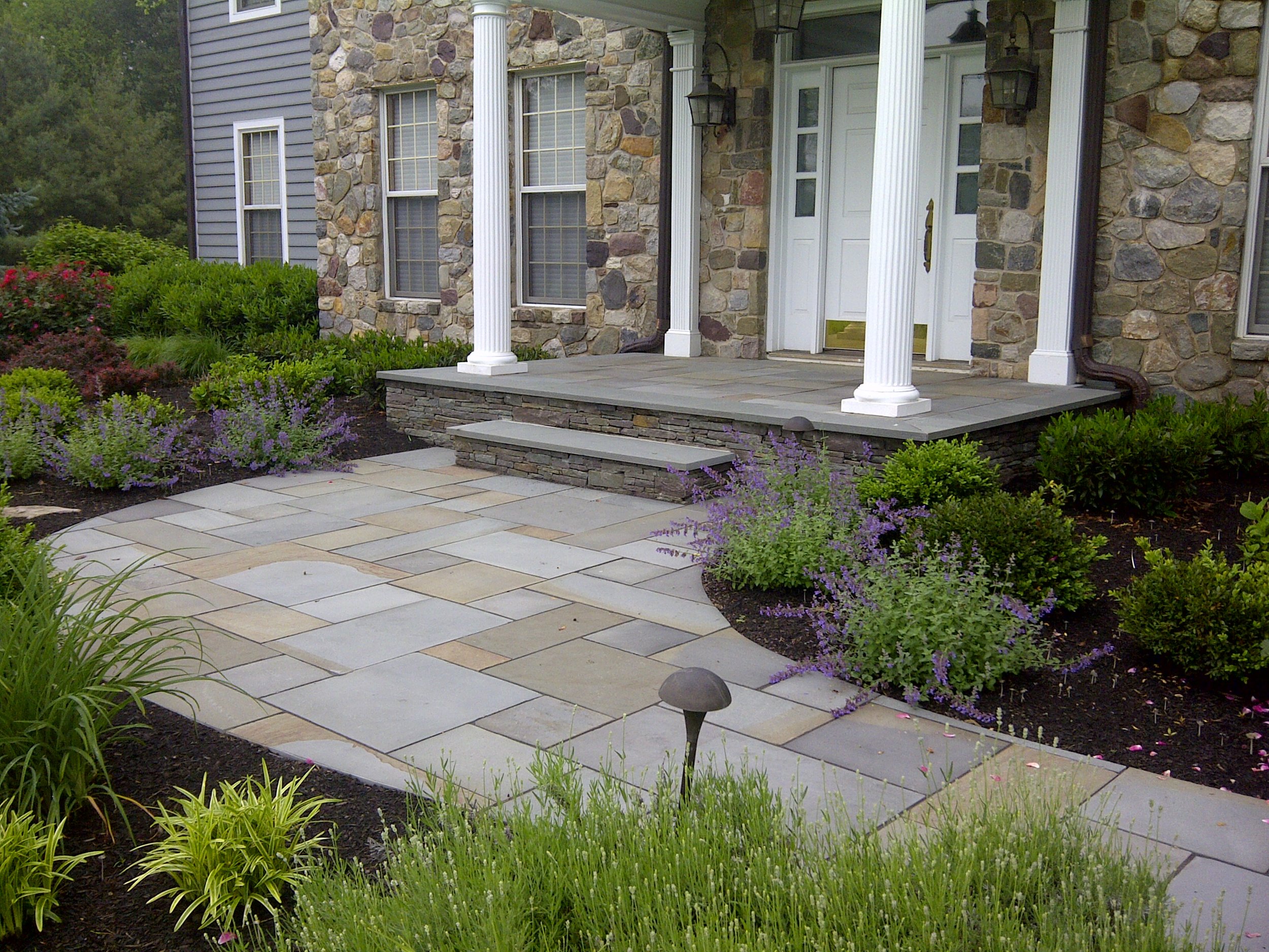 Bluestone walkway and new front stoop with stone facing. Planting and site improvements Upper Makefield PA.