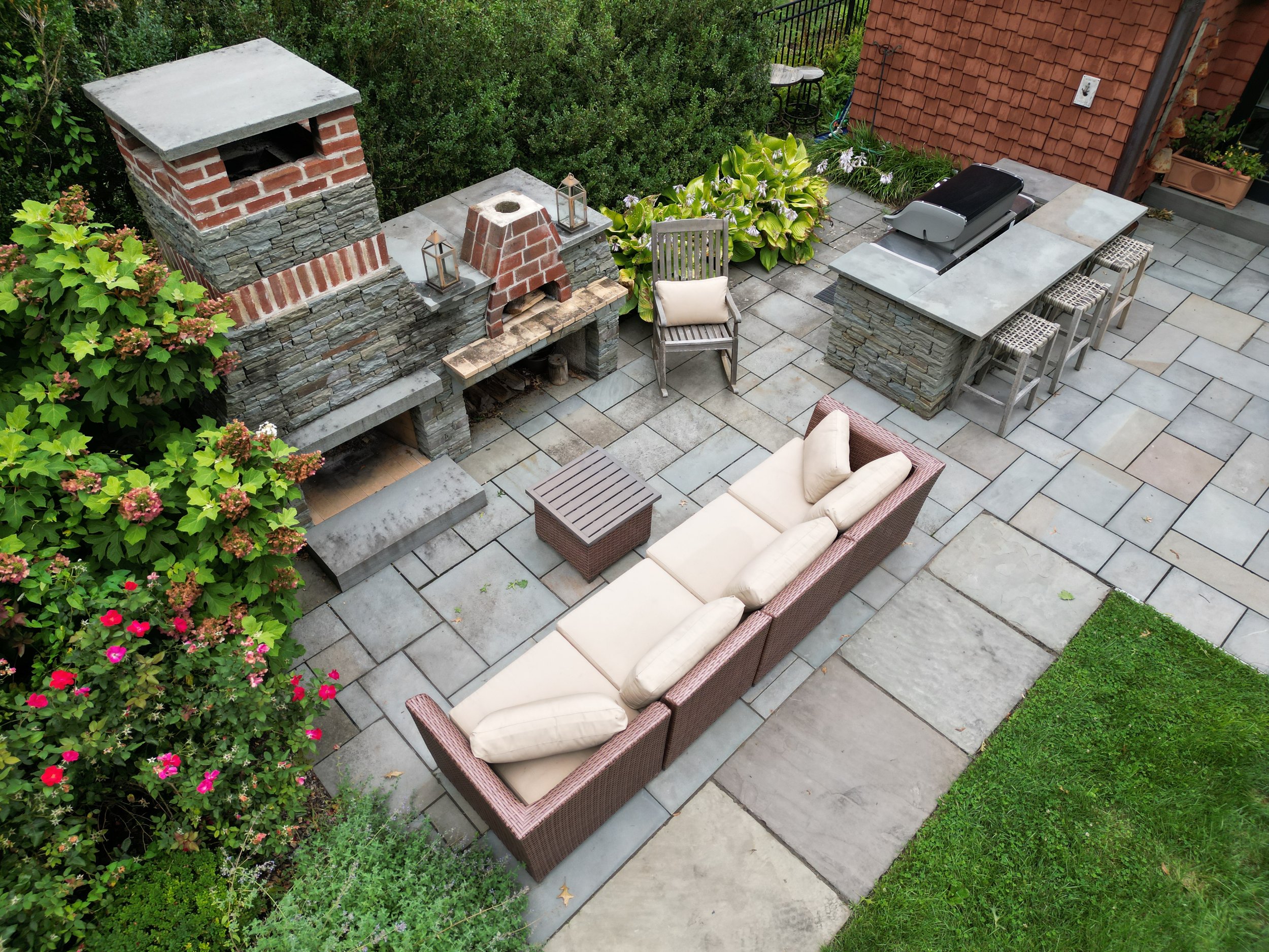 Aerial of outdoor fireplace, pizza oven and grilling station.