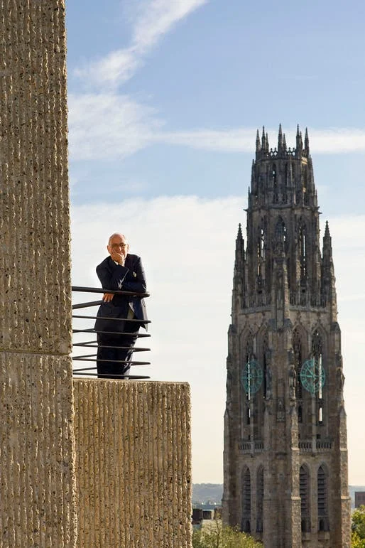 Robert A. M. Stern, former Dean of Yale’s school of architecture. He is shown standing on a portion of Rudolph’s Yale Art & Architecture building. Yale’s Harkness Tower is in the background. Photo: Peter Aaron/OTTO