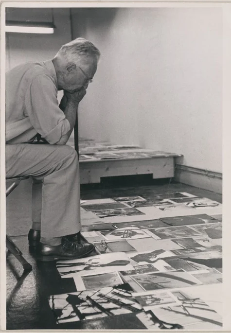 Edwin Steichen, the Director of the Museum of Modern Art’s Department of Photography, facing the task of selecting & organizing photographs for the exhibit. Photo: MoMA