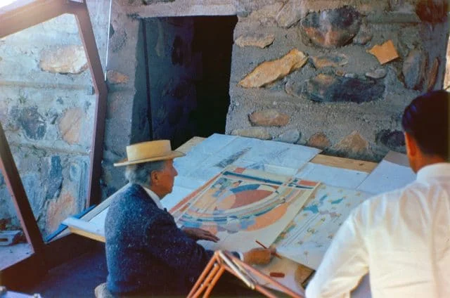 Frank Lloyd Wright (photographed circa the 1950’s) looking at a design he’d submitted for Liberty Magazine in the 1920’s. Image: www.franklloydwright.org