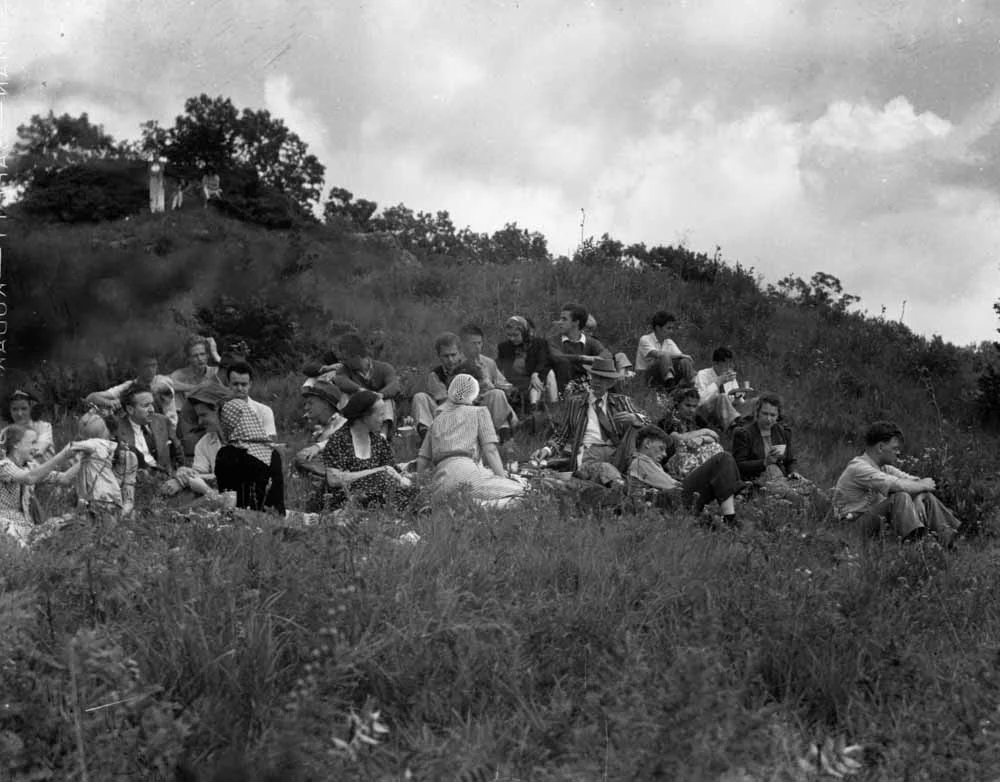 Frank Lloyd Wright and members of his Taliesen Fellowship, out for a countryside picnic. Wright is seated just right-of-center, in the hat and striped jacket. Photo by Pedro E. Guerrero , a superb photographer of architecture and the arts (many of whose works are collected in fascinating books )—and who is well-known for creating some of the most memorable images of Wright and Wright’s community. Photo (c) The Estate of Pedro E. Guerrero