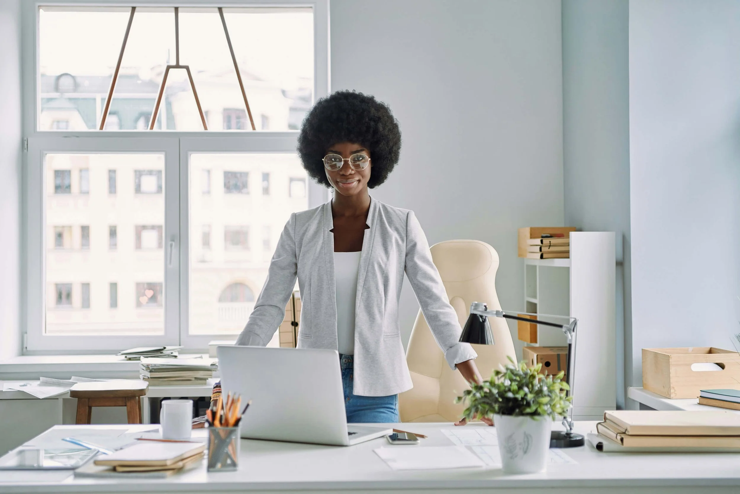 Confident woman at desk in office