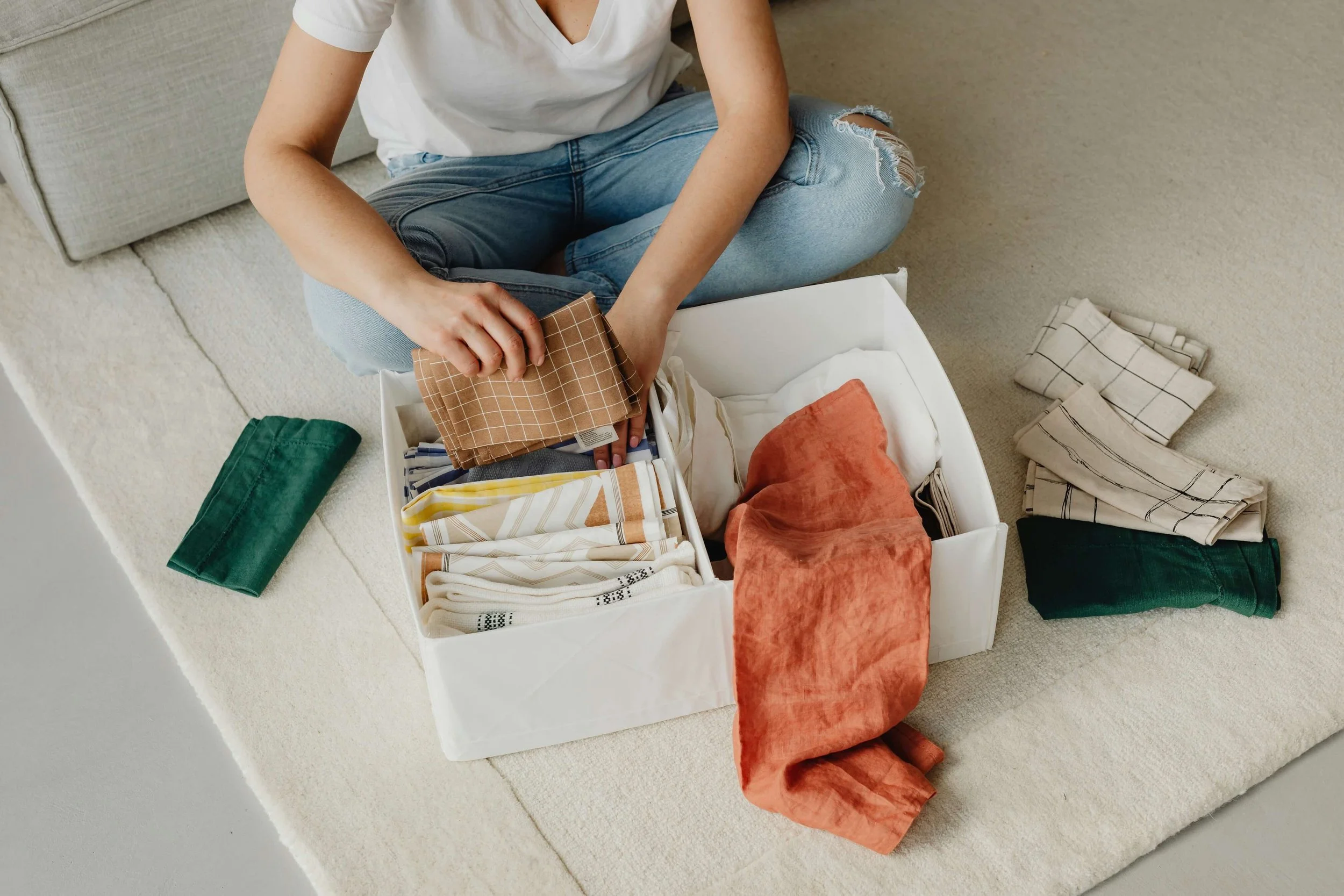 Woman putting clothes in box
