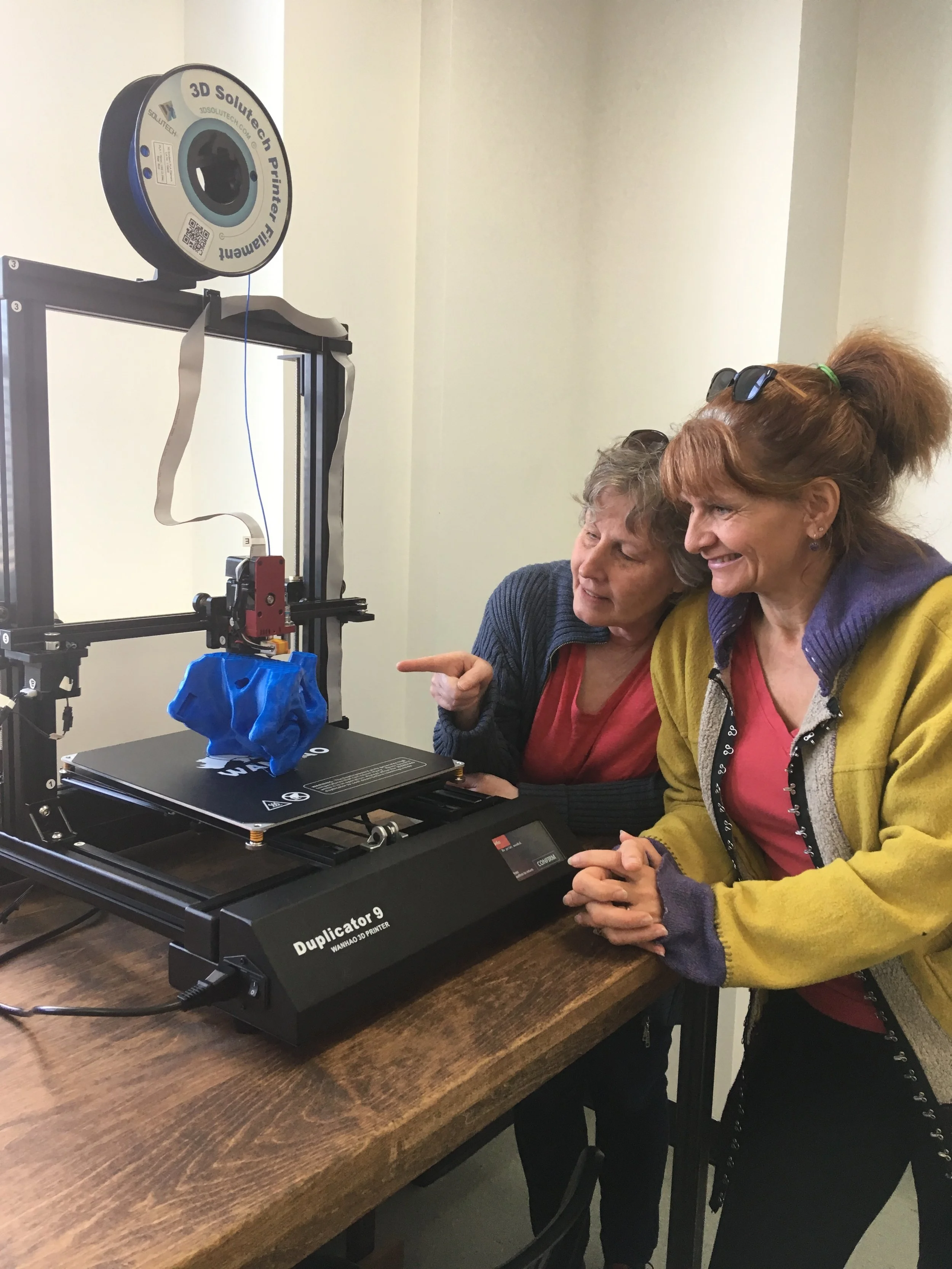 Rena and Peggy check out a large scale 3D printer at Maker North.