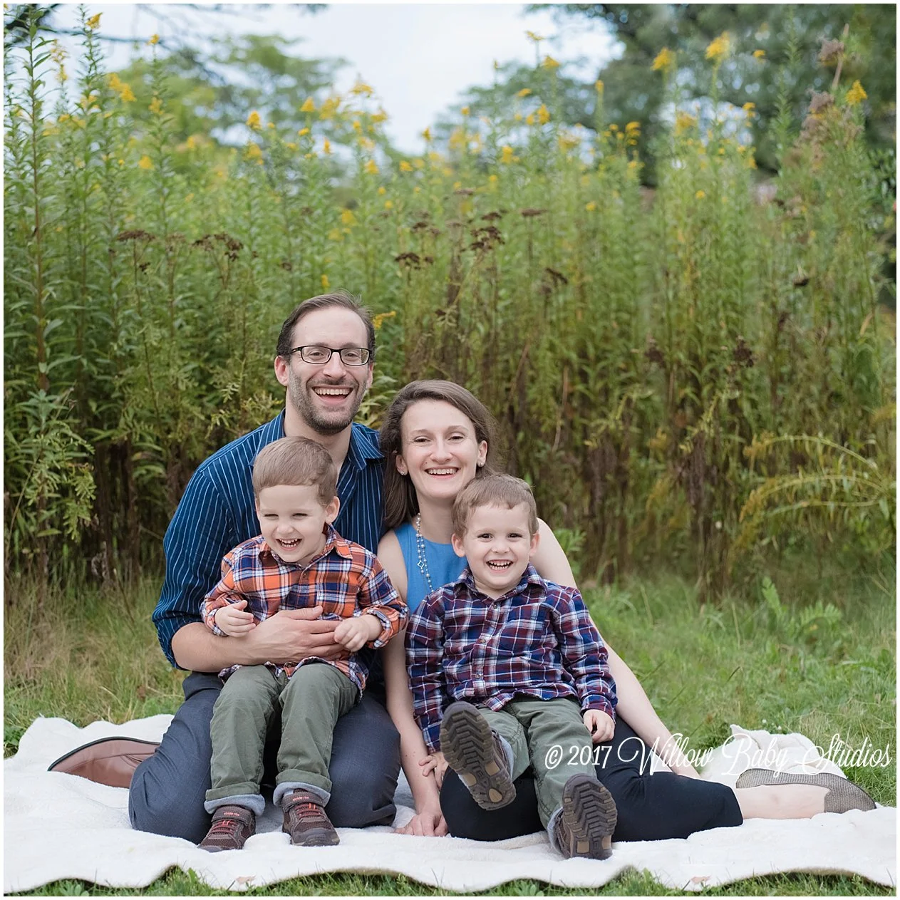 family of four smiling lots