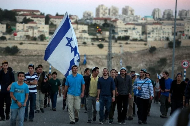 Israelis march from the illegal settlement of Maale Adumim to the E1 zone in February 2014 (AFP)