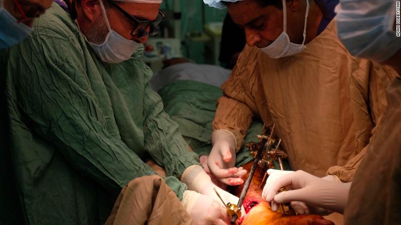 Abu-Sitta operating on a patient with a limb injury.