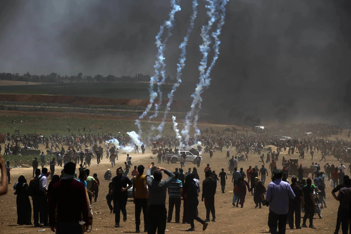 Palestinian protesters gather to demand the right to return to their homeland, on the occasion of the 70th anniversary of the "Nakba", and against U.S. embassy move to Jerusalem at the Israel-Gaza border, in Beit Lahia, in the northern of Gaza Strip, on May 14, 2018. (Photo: Ramez Habboub/APA Images)