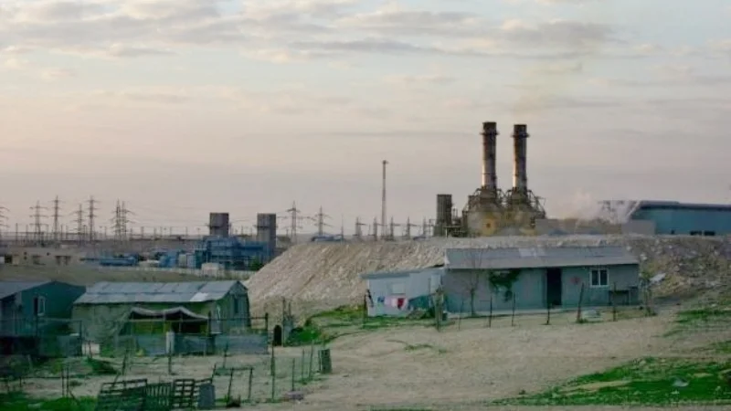 Bedouin houses sit in entrance of an Israeli energy plant at Wadi al-Naam, close to Beersheba. Photograph: AP