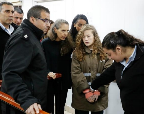 Ahed Tamimi enters court in handcuffs.