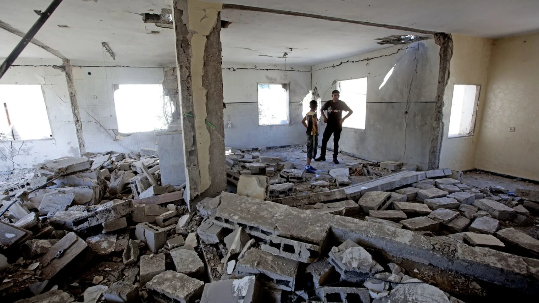 Neighbors view the what is left of the home of Ziad Awad, who was suspected (not convicted) of murdering an off-duty policeman. At the time (summer of 2014), the IDF was considering also demolishing the homes of Hamas leaders in the West Bank, as well as those of Palestinian prisoners released in a prisoner exchange 3 years earlier, and at least 8 other Palestinians. ( Ha’aretz )