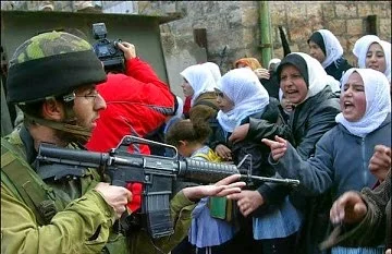 Israeli soldier threatens a group of (unarmed) women.