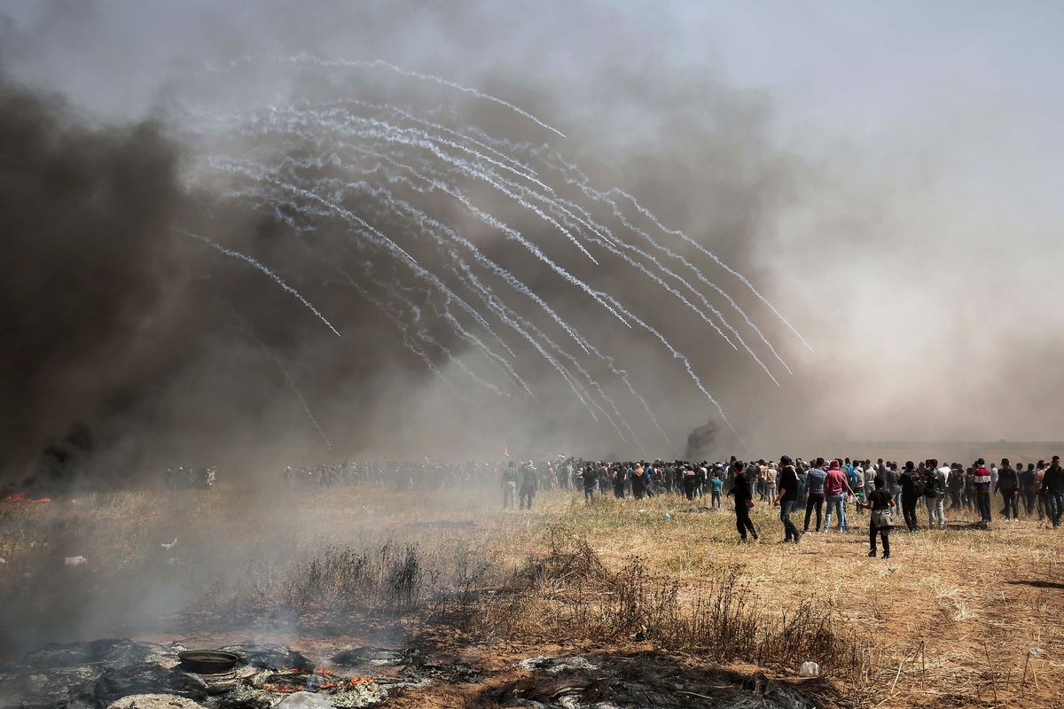 Israeli forces fire tear gas at Palestinian protestors during clashes on the Gaza-Israel border on April 6, 2018. SAID KHATIB/AFP/Getty Images