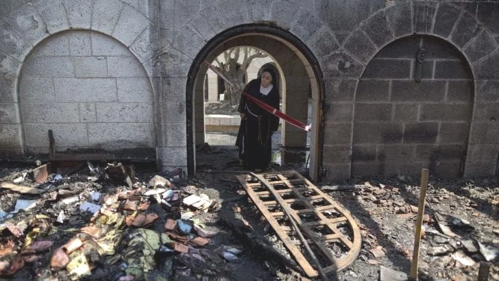 A nun inspects the damage at the Church of the Multiplication at Tabgha, Ariel Schalit/AP