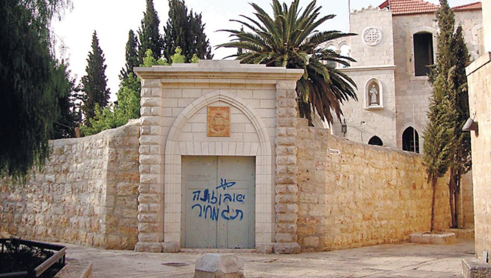 Graffiti reading 'Jesus, son of a bitch, price tag,' was found on a door near the Franciscan monastery on Mount Zion, just outside the walls of Jerusalem's Old City. Credit: AP/HO