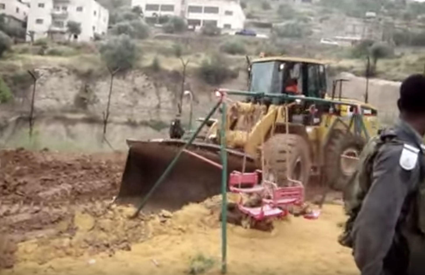 Screengrab from video as Israeli bulldozers destroyed a garden, a children’s playground, and 100 fruit and olive trees in the Bethlehem district, to make way for the continued construction of their illegal wall. Soldiers used violent force to remove Palestinian, Israeli, and international activists who attempted to prevent the destruction. Two Israelis were arrested immediately, and six internationals were later arrested. 2010