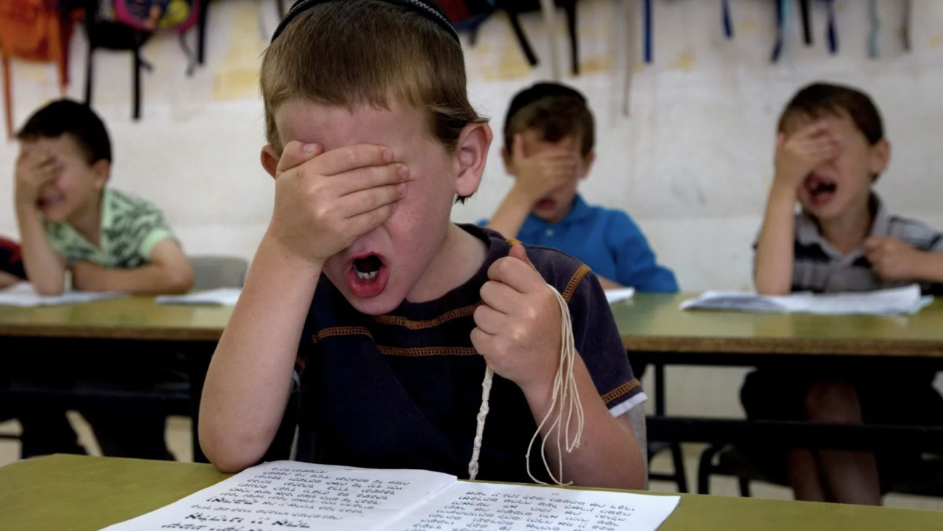 Ultra-Orthodox students pray during a reading class at the Kehilot Yaacov Torah School for boys in Ramot, Jerusalem. RONEN ZVULUN/REUTERS