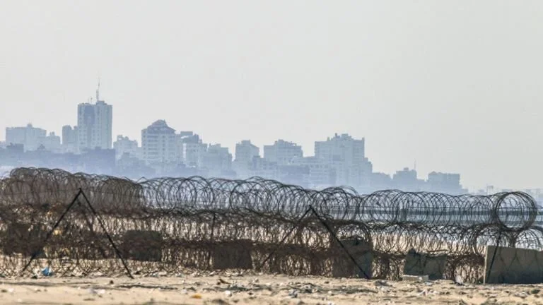The skyline of Gaza City from the beach in the Israeli kibbutz of Zikim