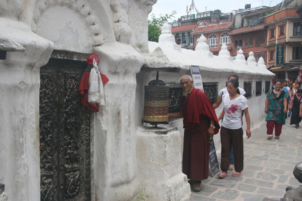 Tibetan man and prayer wheel