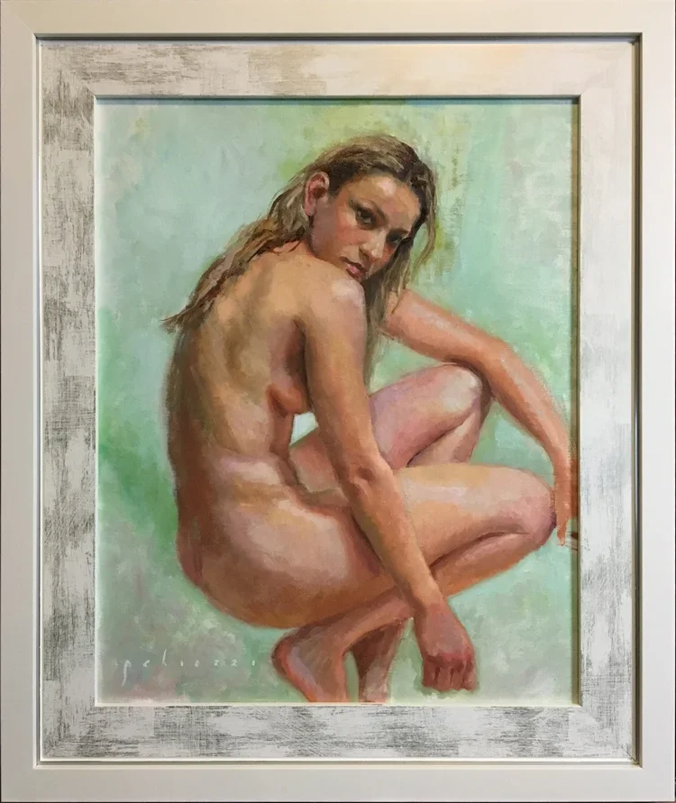 A realistic painting of a nude woman with long hair, sitting with one knee up and her arm resting on it, looking over her shoulder, set against a soft green background.