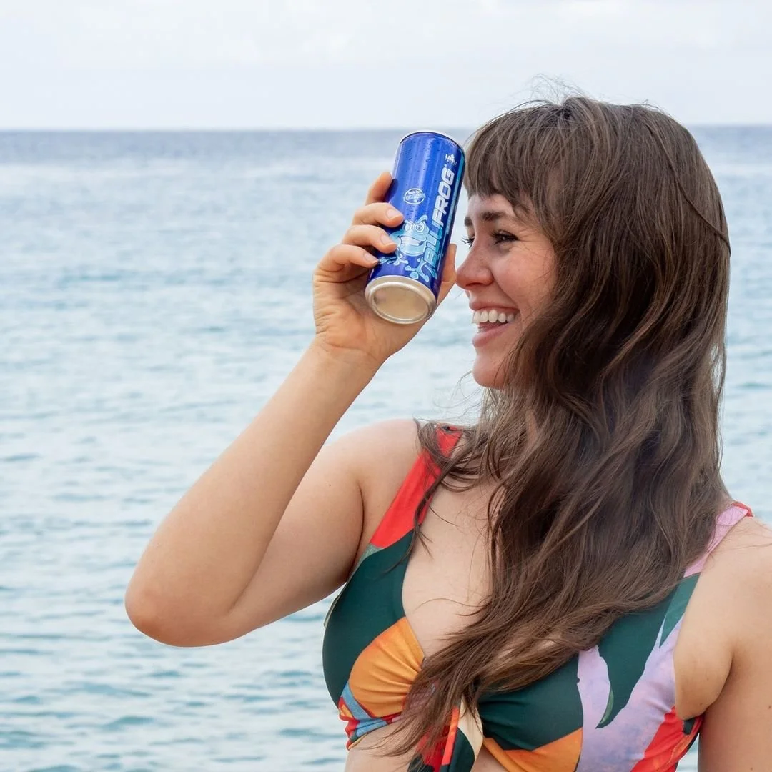 Woman Holding a Can of LIMU BLU FROG 2 - Best Nootropic Energy Drink - Close to Her Face