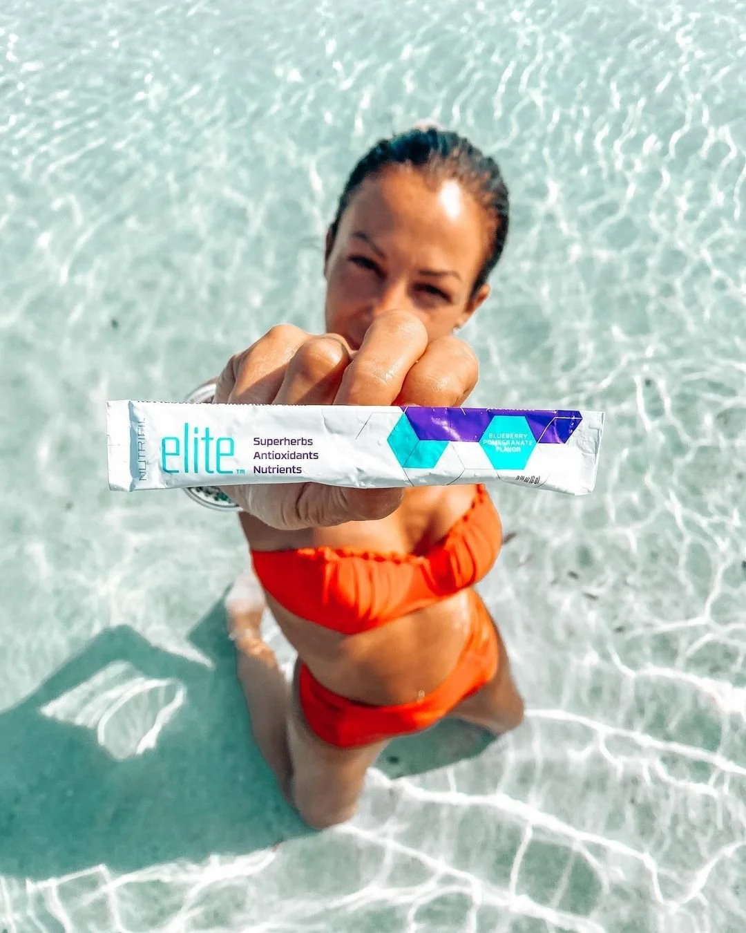 Woman Holding a Packet of Nutrifii Elite - Anti-Aging Powder Drink