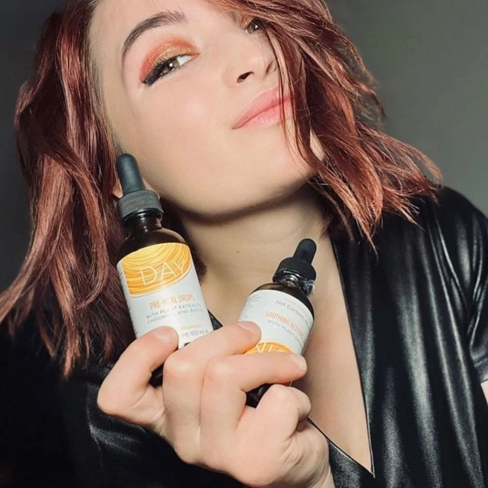 Woman Holding Bottles of Slenderiiz Day & Night Drops in Her Hand