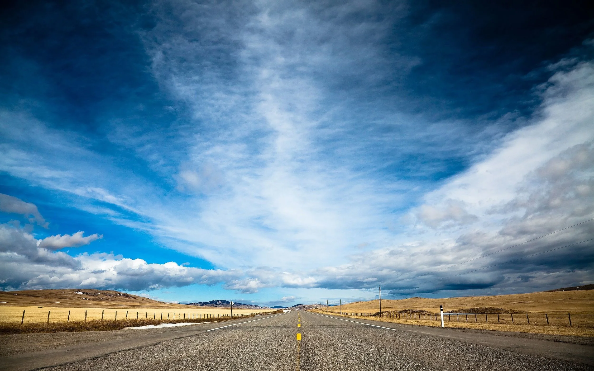 road_and_cloudy_blue_sky-wide.jpg