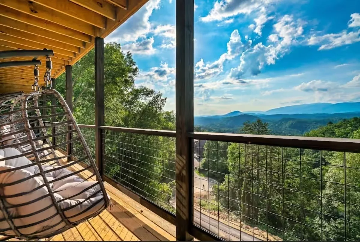 2026 daytime porch with hanging chairs.jpeg