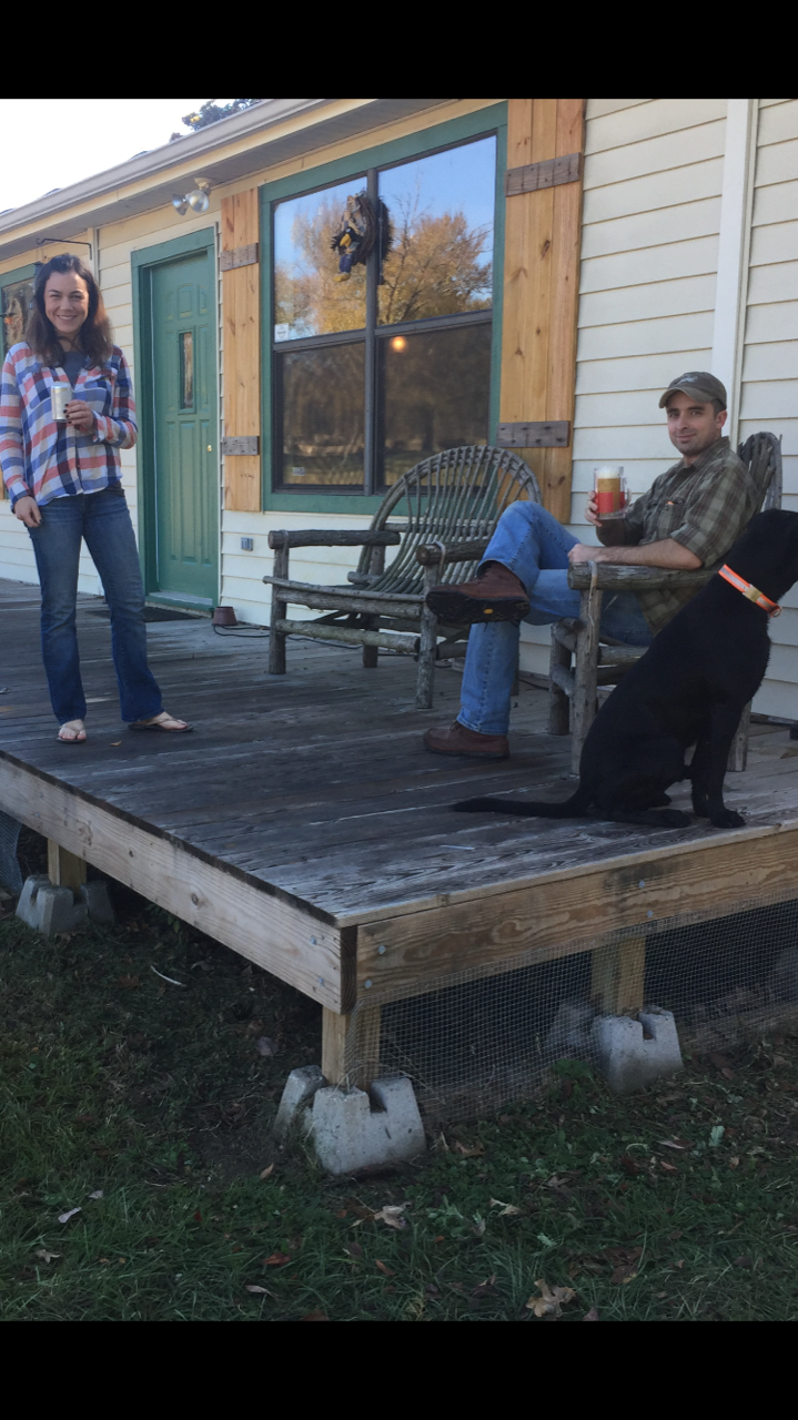 Barron & Jana relaxing on the front porch of the cabin.  It is covered now.