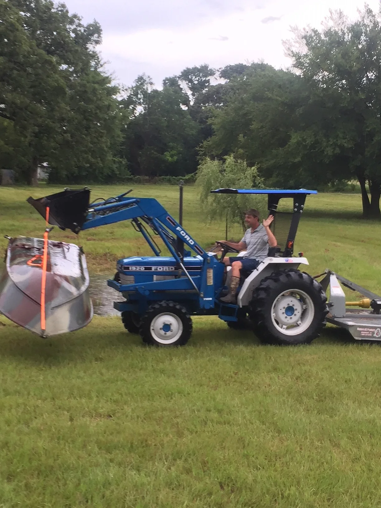 Yes, he is moving a boat...with a tractor