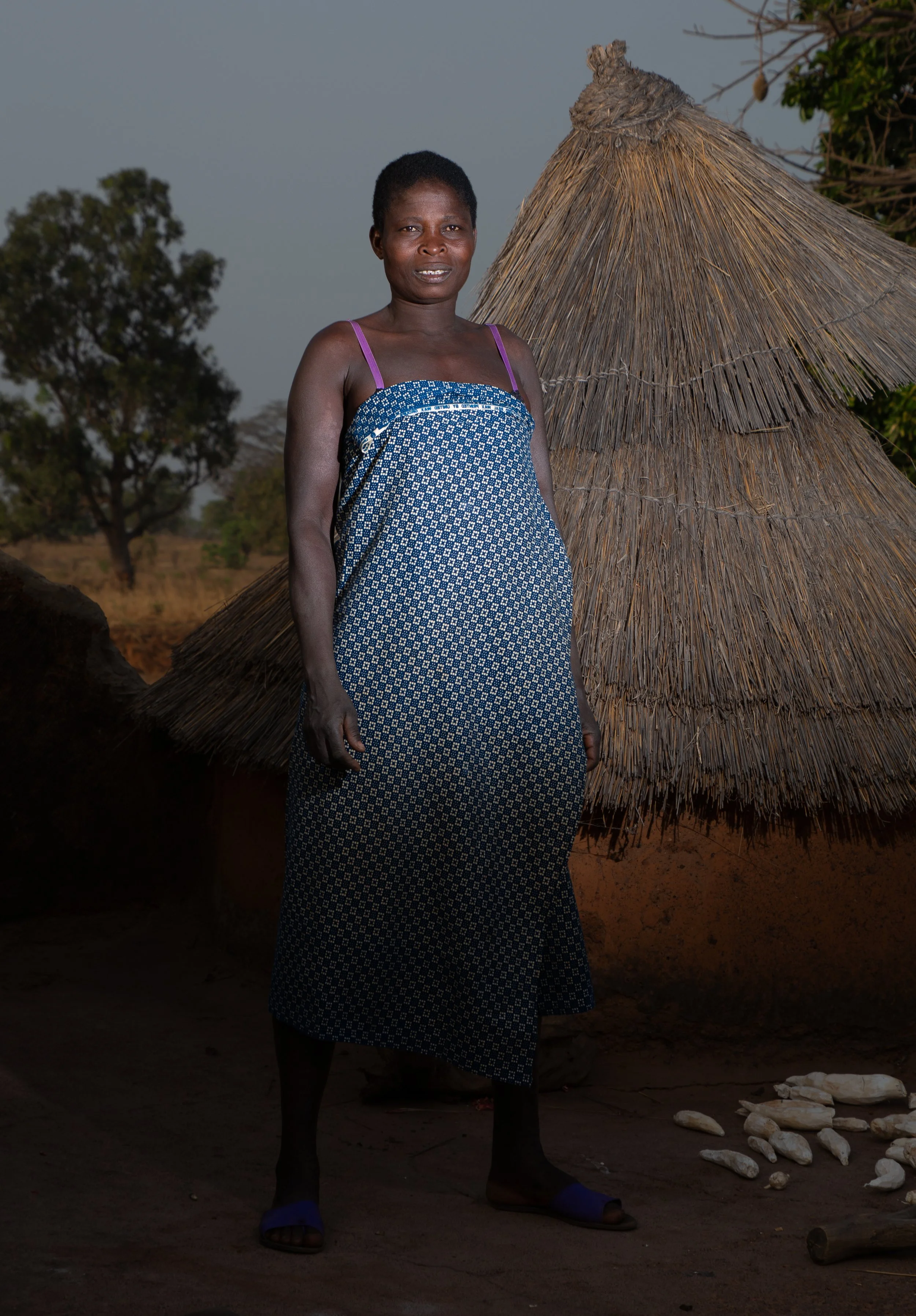 Portrait of Maman Jo in Boukoumbé, keeper of the hearth, mother of Fiacre and Lucien, proud and protective of her home.