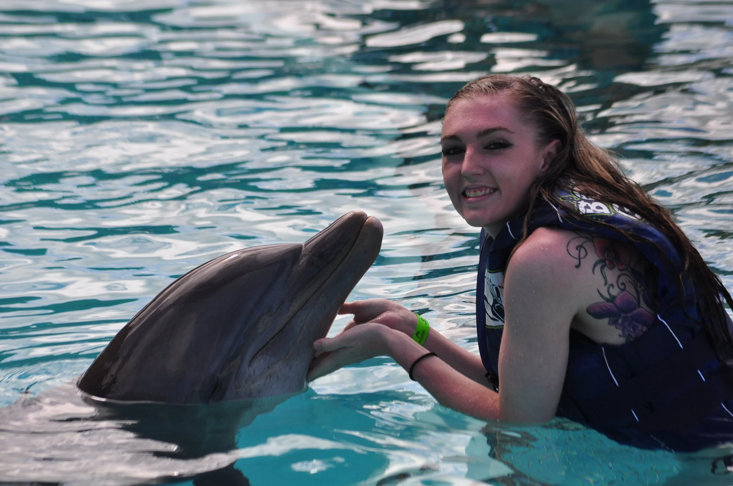 Caitlin Smiles with a Dolphin.JPG