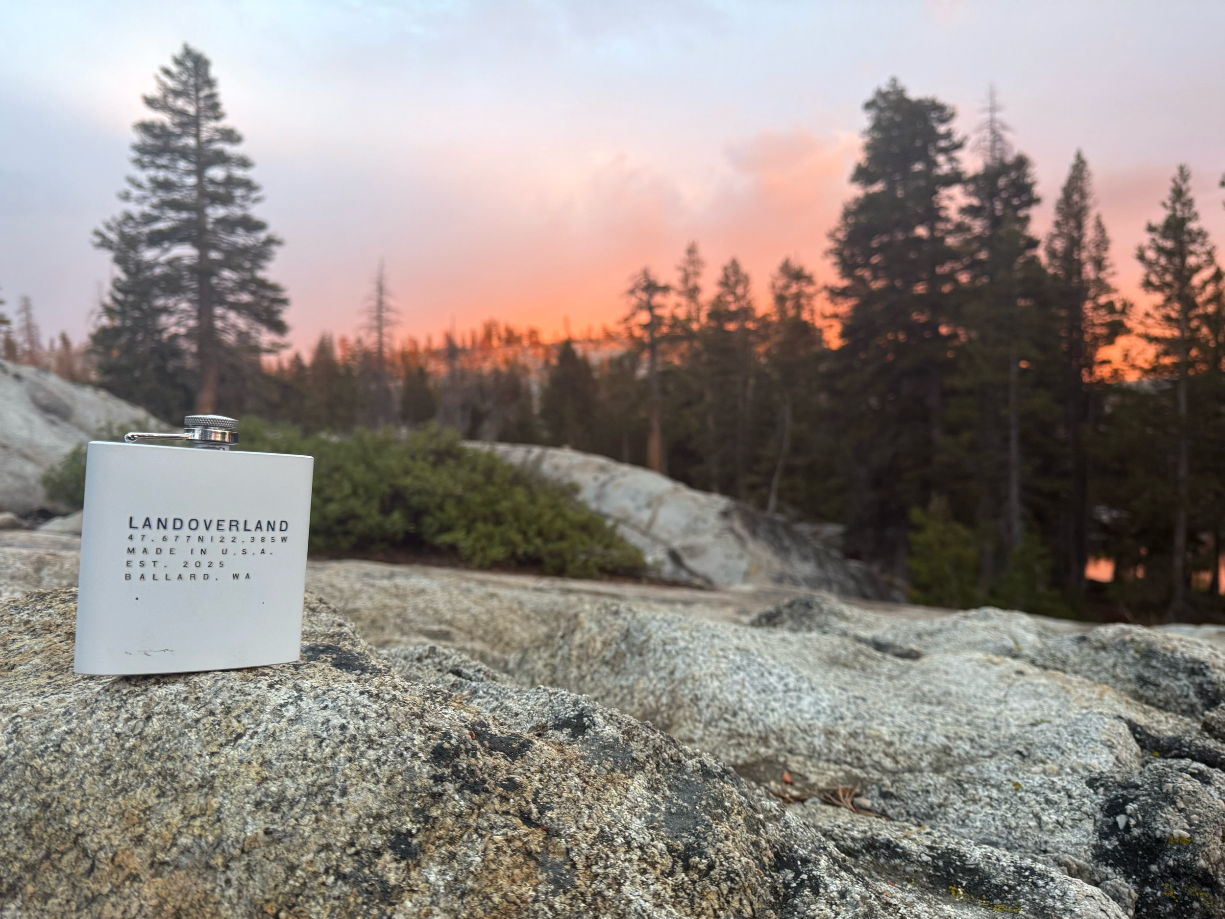 LANDOVERLAND stainless steel hip flask, featured as a classic companion for camping weekends and cabin getaways.