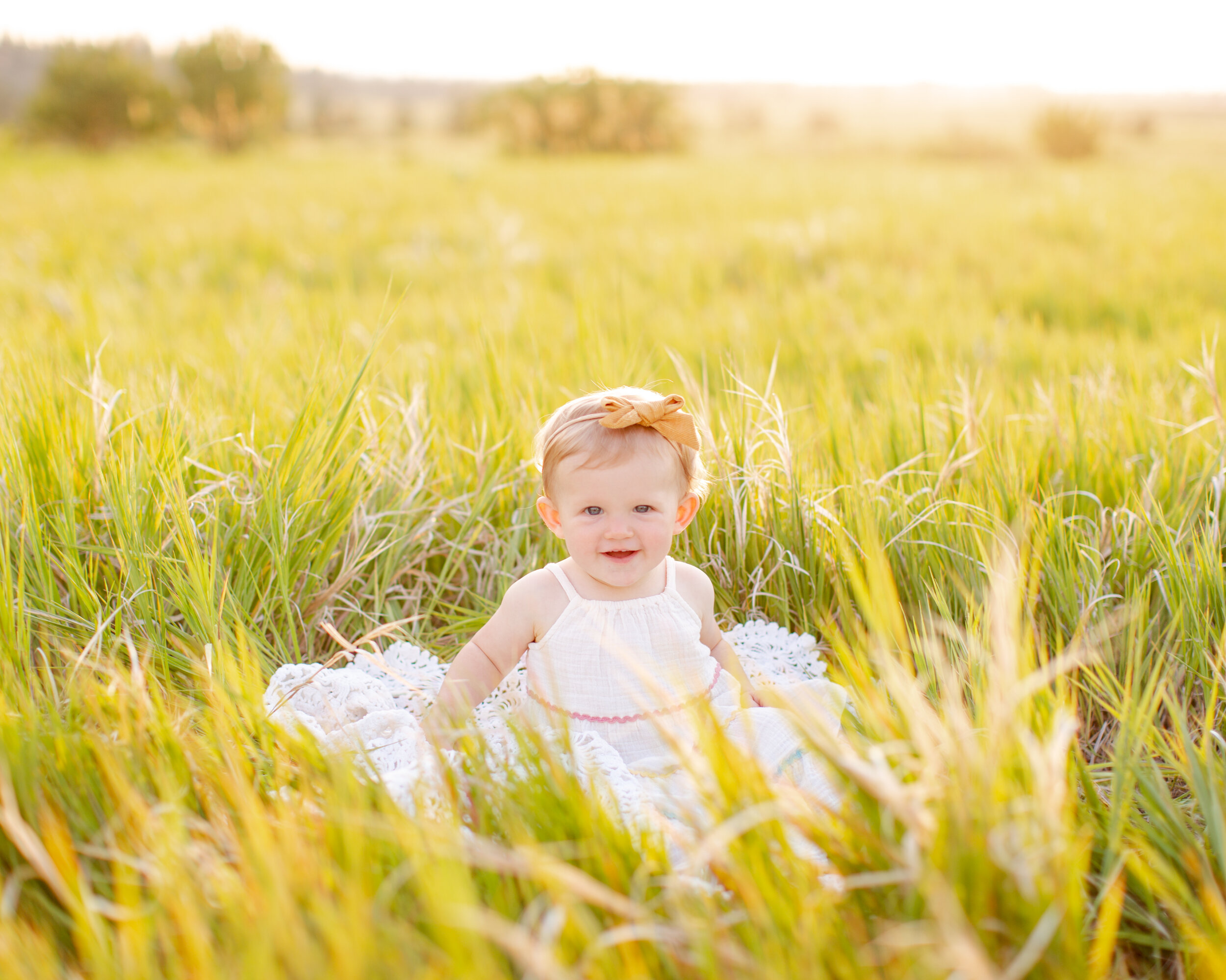 baby girl in a field of grass