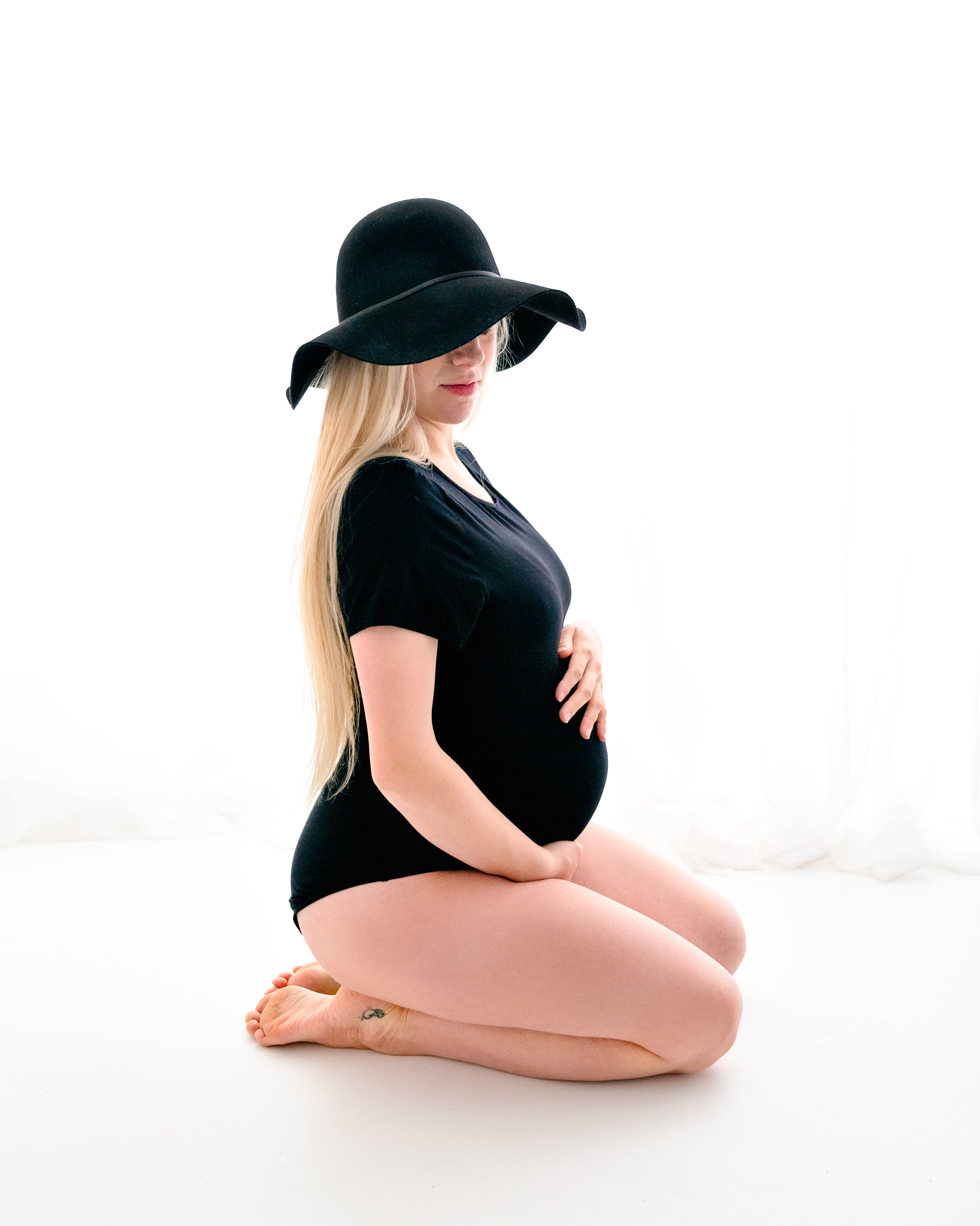 backlit image of expecting mama in a photography studio