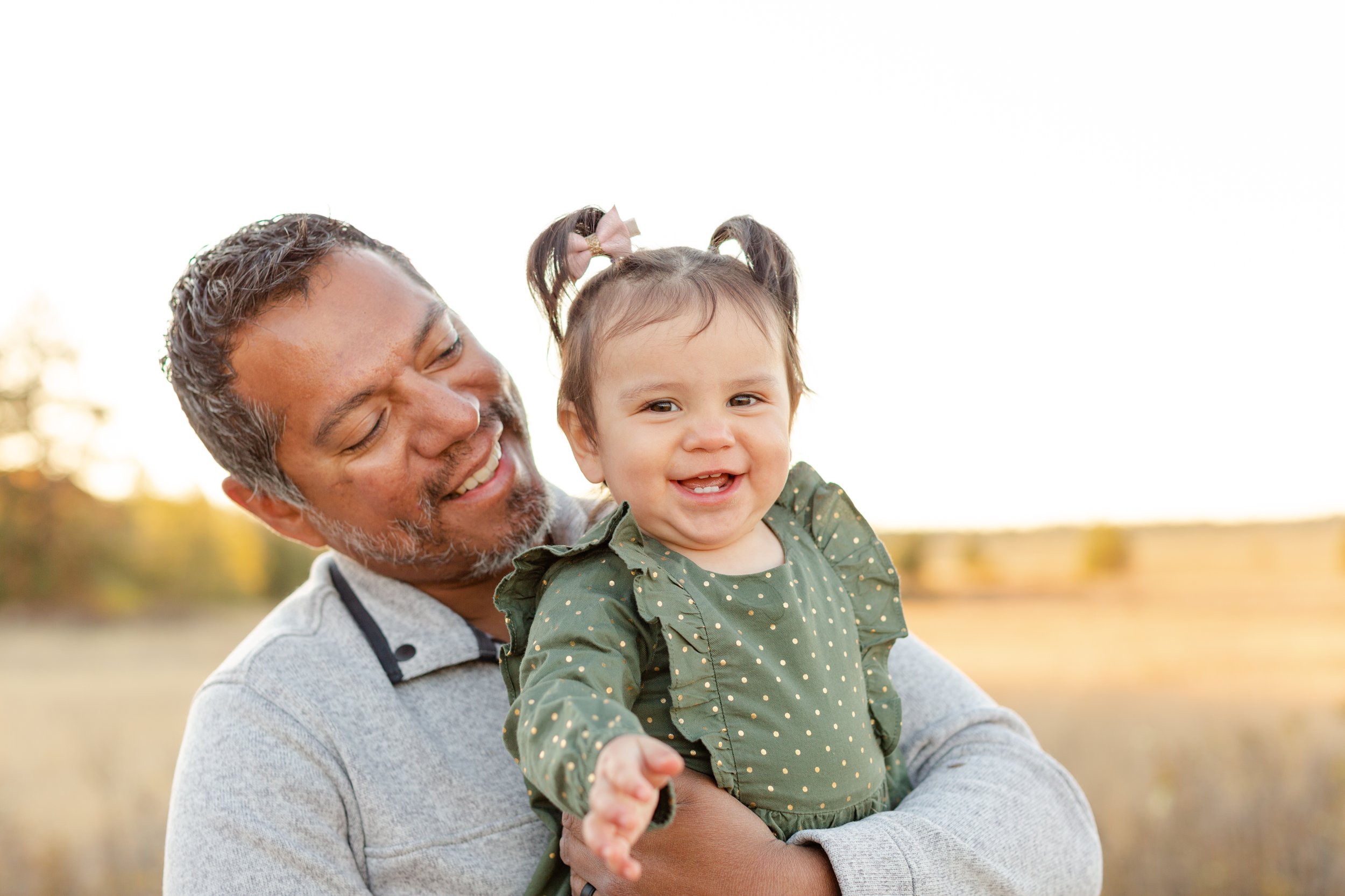 dad and baby smiling together