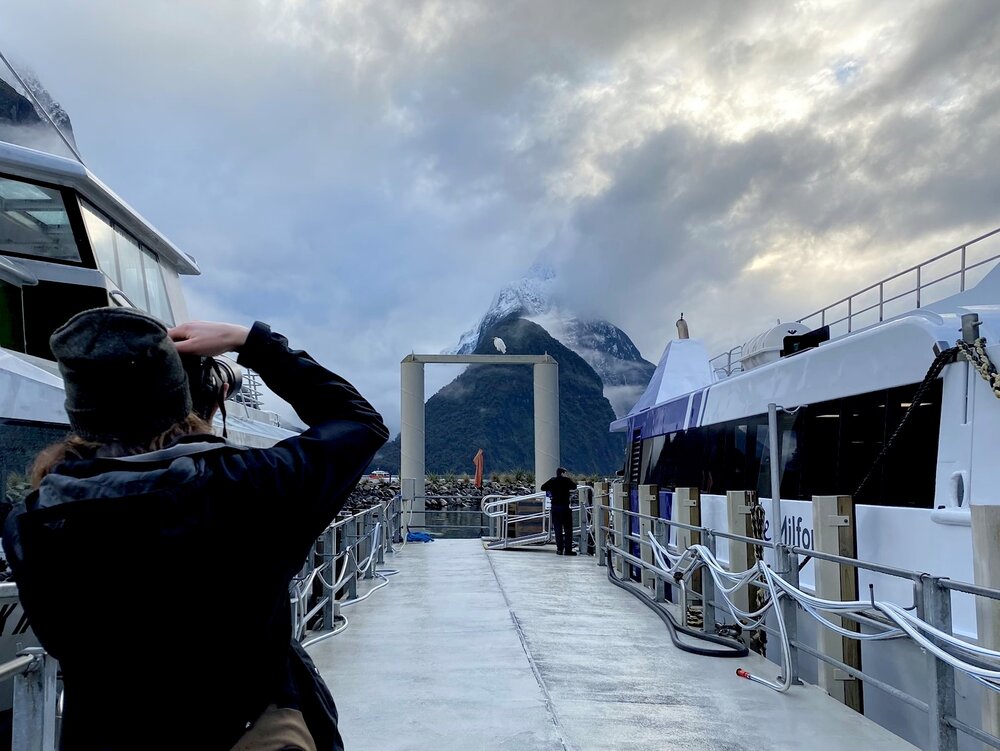 Hannah photographs Herman on the dock at Milford Sound