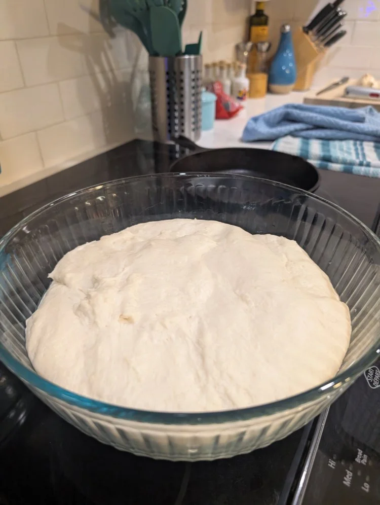 garlic naan dough that has risen and is ready to roll
