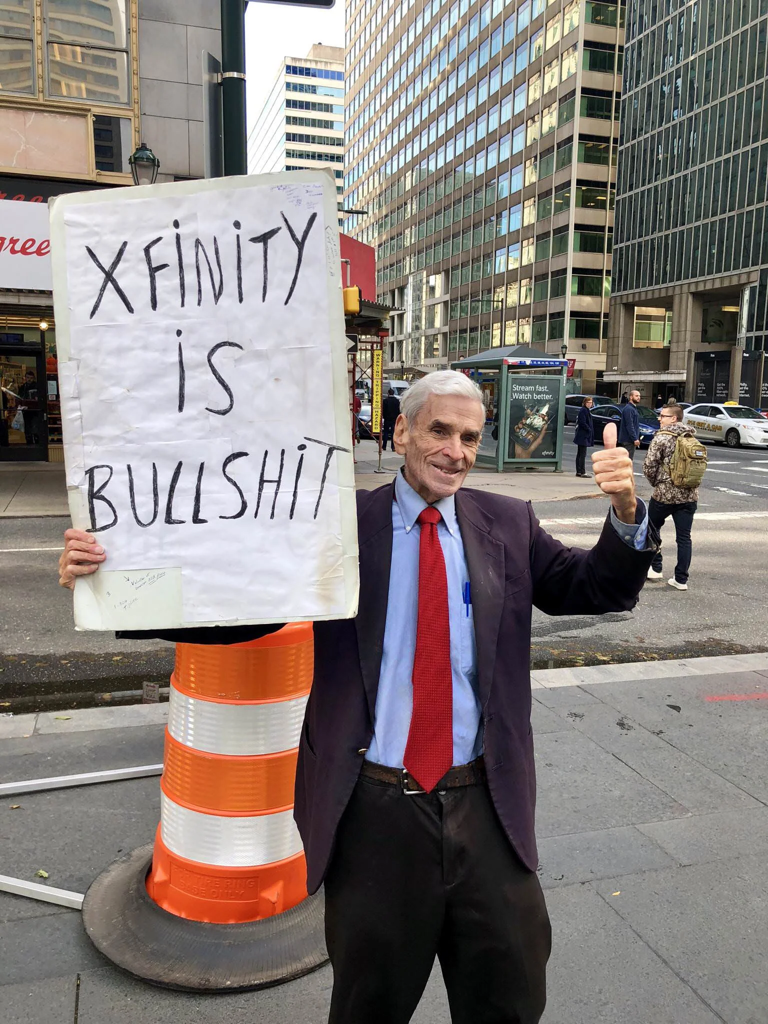 Protest sign outside Comcast headquarters in Philadelphia: “Xfinity is Bullshit”.