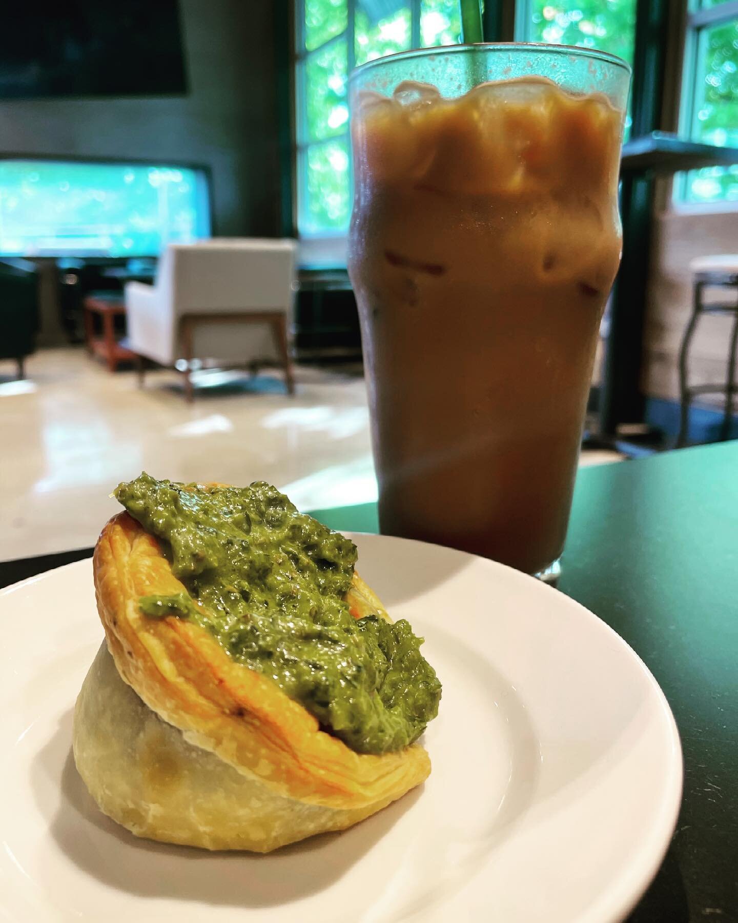 an iced lavender latte with a spinach empanada please!! 🥳 have you visited the @giddycoffee in plaza midwood? it&rsquo;s two floors of a real chill vibe and flavorful breakfast tingsss. #thankmelater